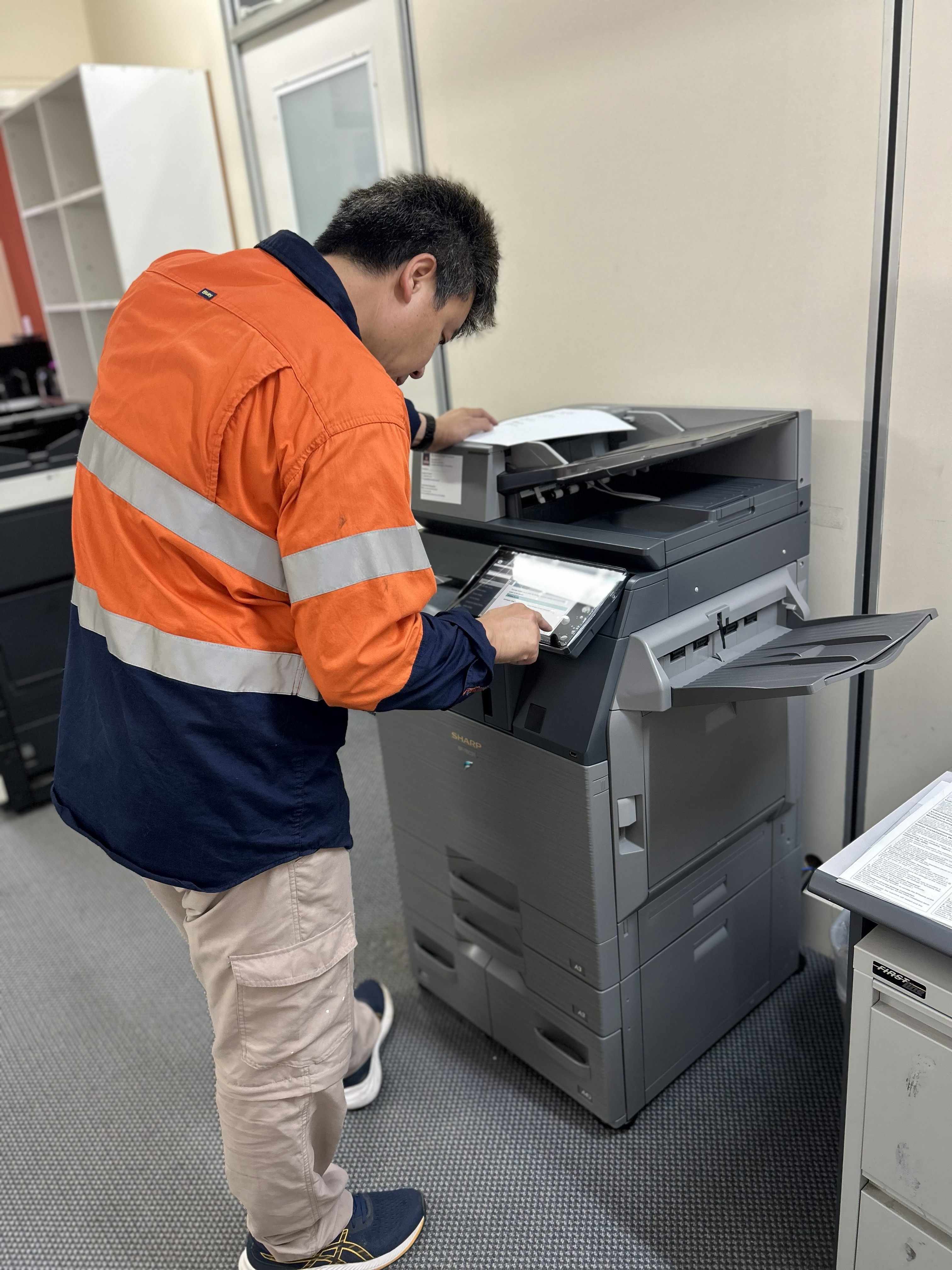 Localworks technician servicing a Sharp multifunction printer